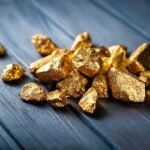 A pile of gold nuggets sitting on top of a wooden table